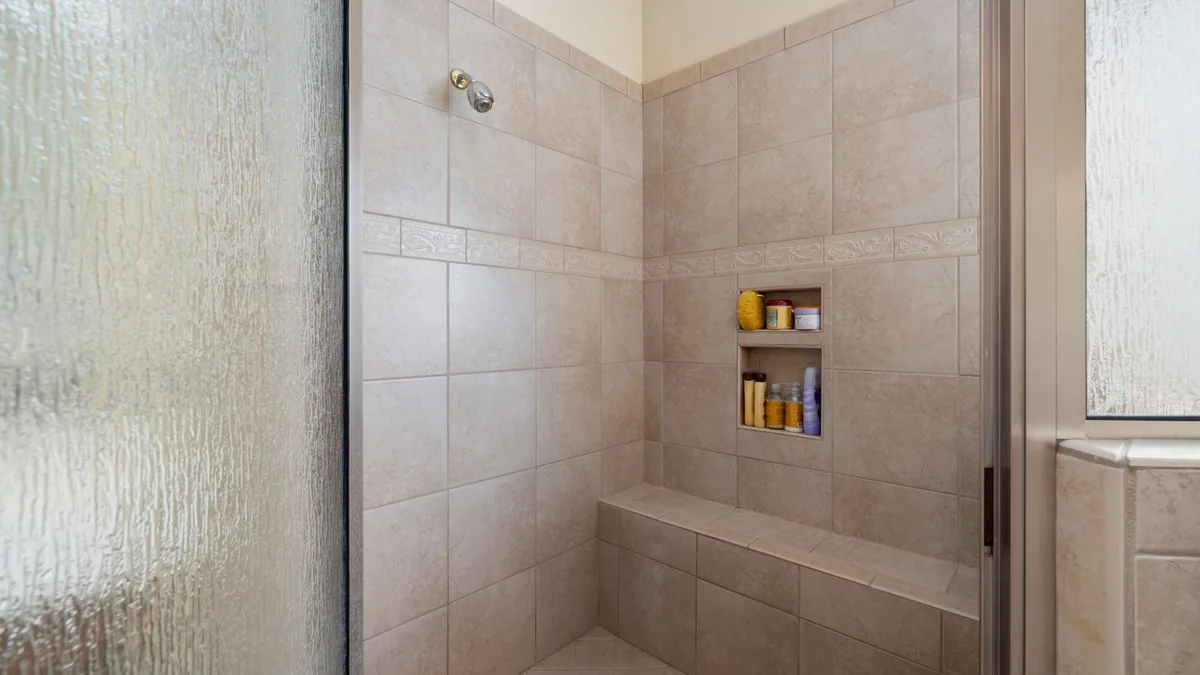 Low-threshold walk-in shower with glass panel in Santa Clarita, CA